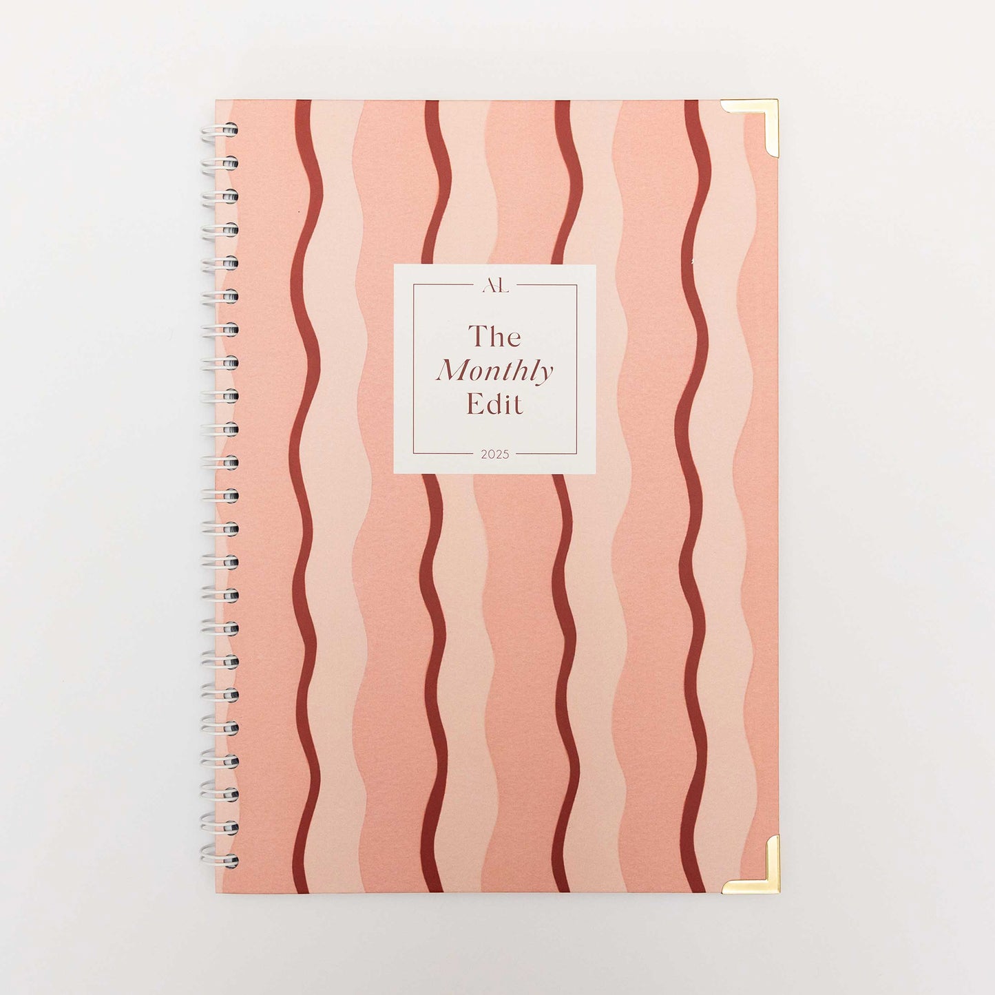 Alexa Lily The Monthly Edit 2025 Planner with pink wavy striped cover and gold corner protectors